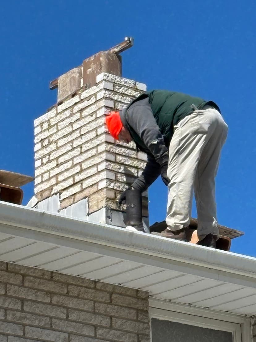 Worker repairing chimney