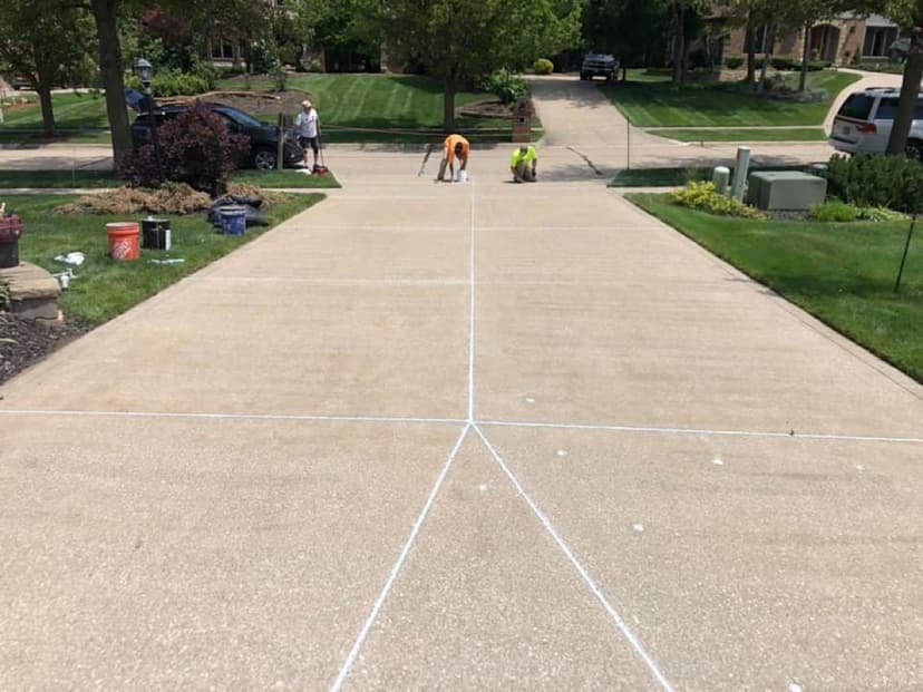 Crew caulking driveway joints